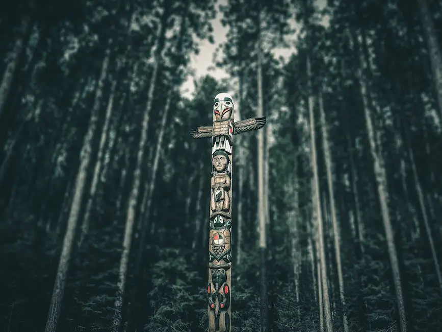 An image of the Old Storyteller sitting in front of a curtain inside the Mystery Lodge, surrounded by totems and symbols of Native American culture.
