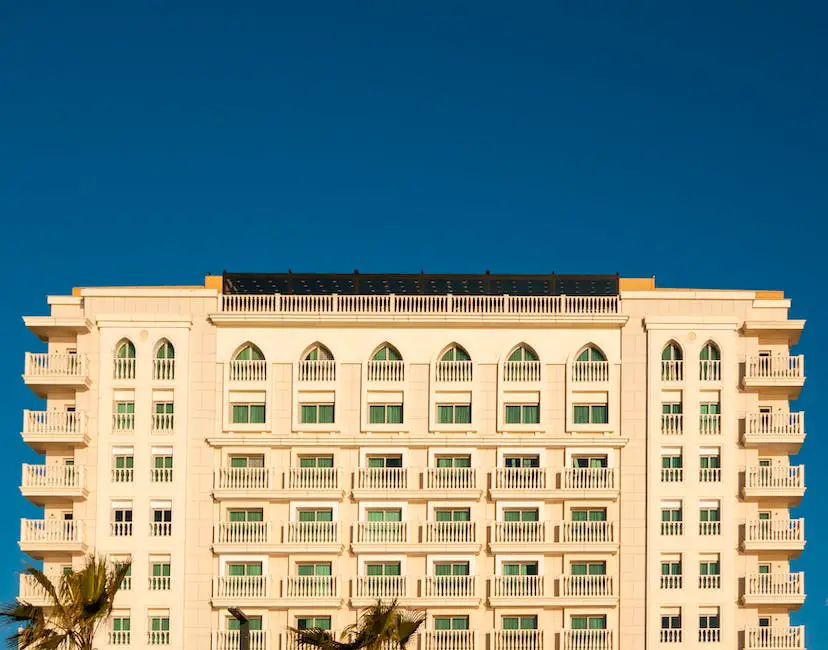 Courtyard San Diego Downtown hotel building with palm trees in front, showcasing the historical elegance with modern amenities of the hotel, inviting travelers to experience America's Finest City.