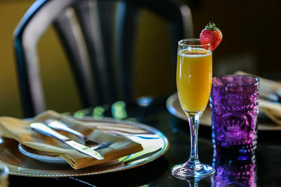 A refreshing glass of mimosa with freshly squeezed orange juice and a bubbly champagne with a champagne flute beside it, in the background, lush green gardens can be seen.