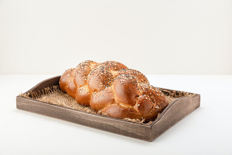 A loaf of Challah bread with bread slices placed on top of it