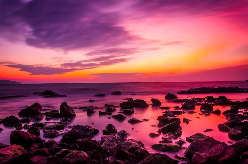 A sunset over the ocean with vibrant colors lighting up the sky and reflecting on the water.